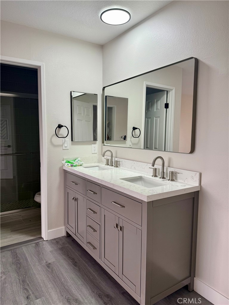 7815 Howe Street, Unit B Paramount, CA 90723 - Photo 10 of 20 a bathroom with a double vanity sink and a mirror