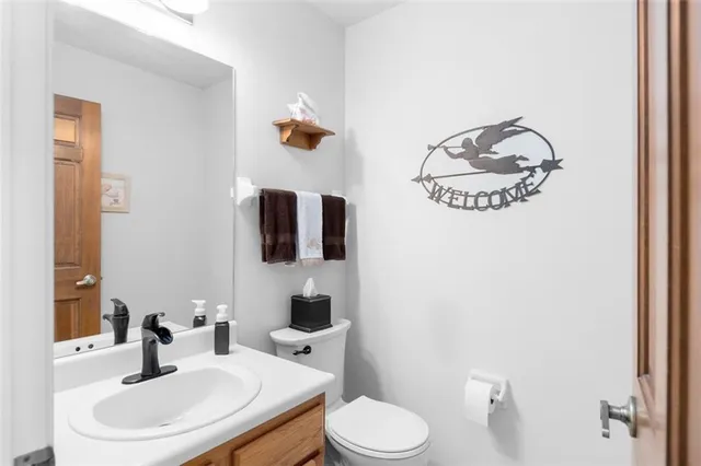 a bathroom with a toilet sink and mirror