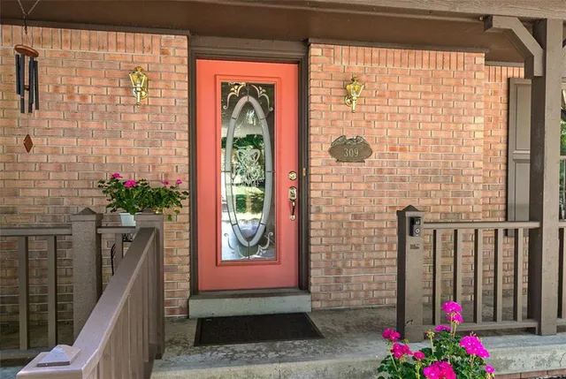 a front view of a house with a potted plant