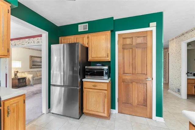 a kitchen with stainless steel appliances granite countertop a refrigerator and a sink