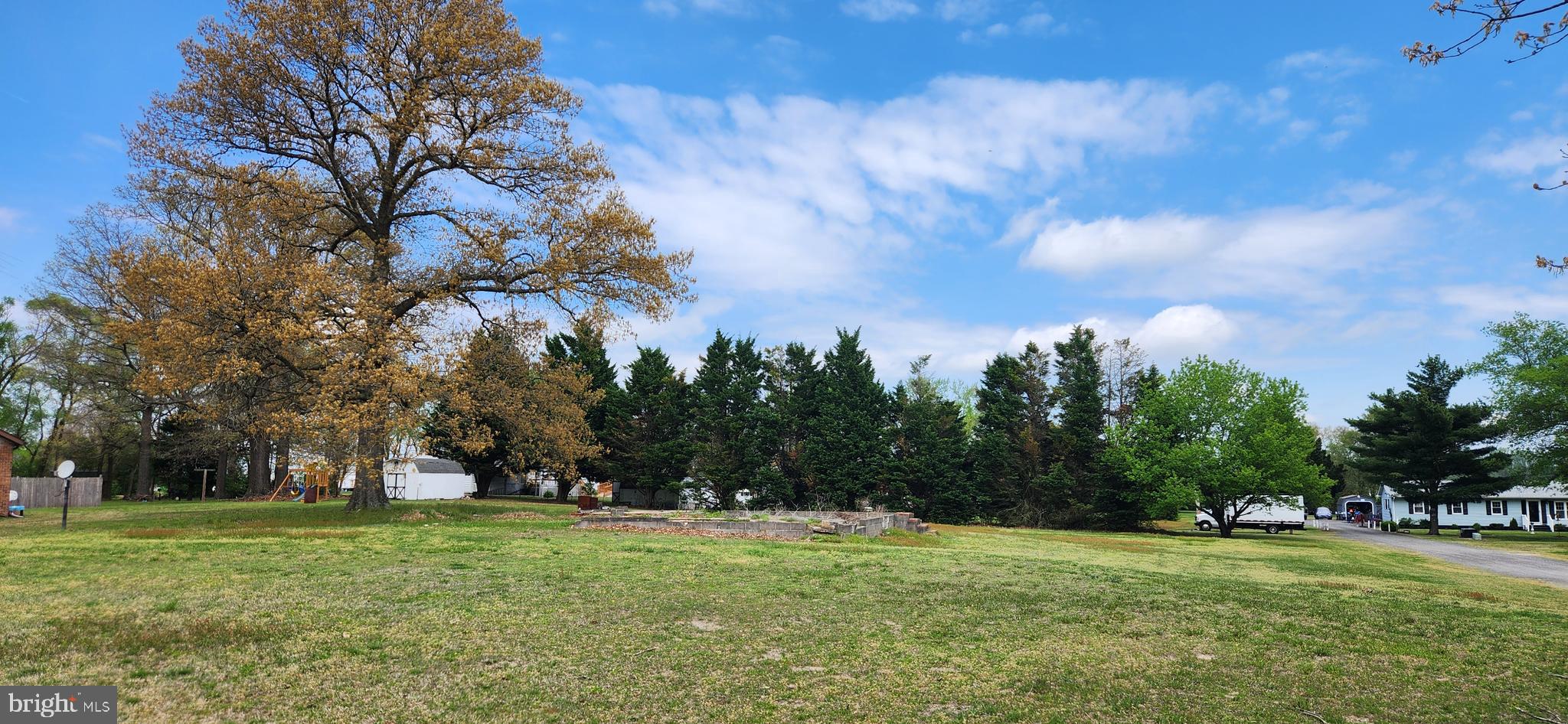 a view of a field with trees around