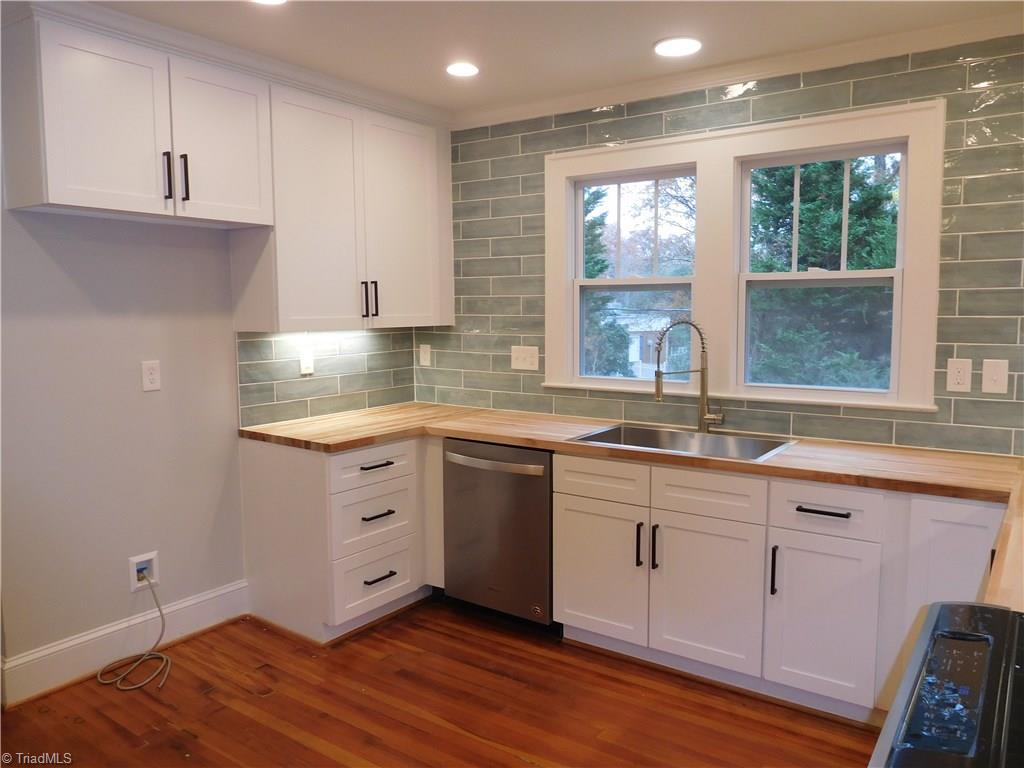 2402 Polo Road Winston-Salem, NC 27106 - Photo 12 of 30 There is a lot of storage and workspace in this beautiful kitchen.
