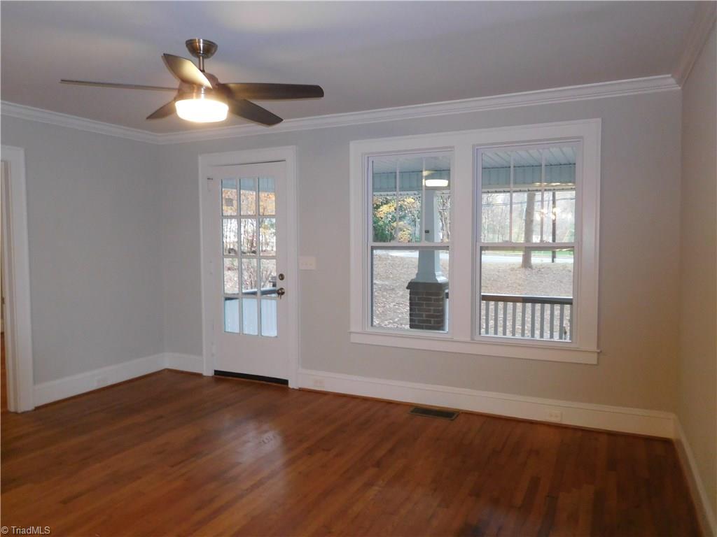 2402 Polo Road Winston-Salem, NC 27106 - Photo 3 of 30 Living room w/tons of natural light. Original hardwoods throughout home. Fresh interior paint, crown molding & new fixtures.