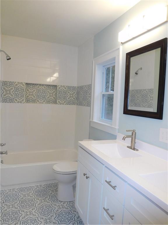 2402 Polo Road Winston-Salem, NC 27106 - Photo 21 of 30 All NEW Master Bathroom. Tile floor & tile tub/shower surround. Double sink vanity. Both bathrooms are completely new.