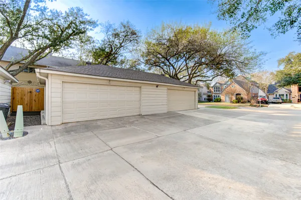 a view of garage and with trees