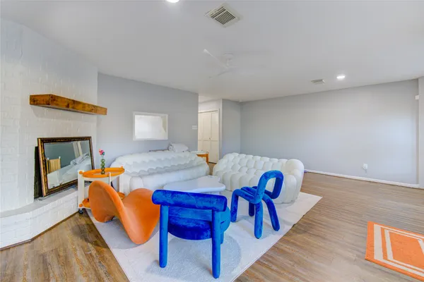 a view of a livingroom with furniture and a dining table
