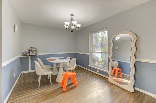 a workspace with furniture wooden floor and a chandelier