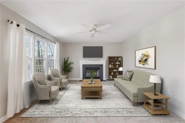 an empty room with windows and fireplace