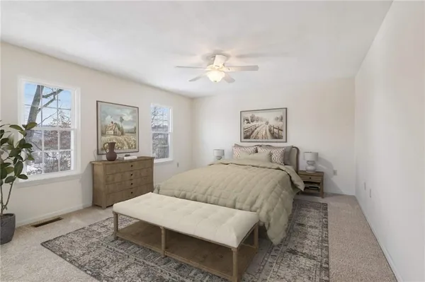 an empty room with windows and fan