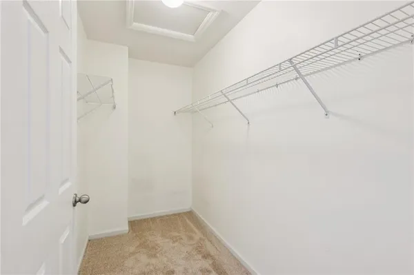 an empty room with wooden floor and ceiling fan