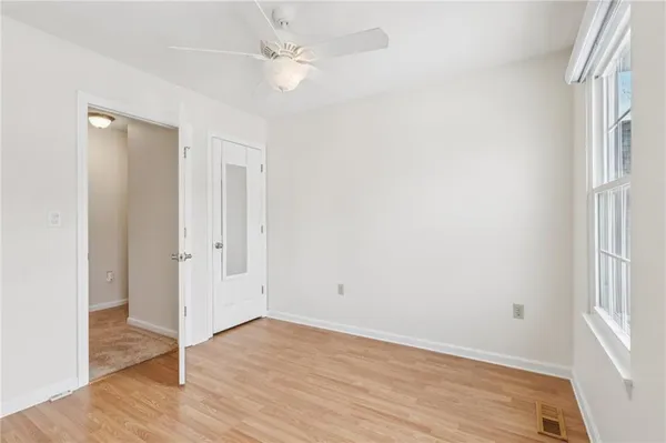 wooden floor in an empty room with a window