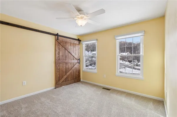 a view of an empty room with a ceiling fan