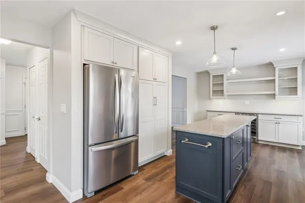a kitchen with stainless steel appliances granite countertop a refrigerator a sink and a stove