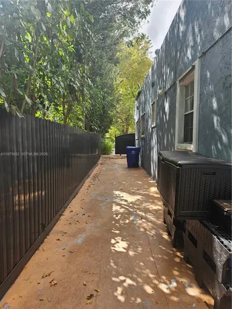 a backyard of a house with table and chairs