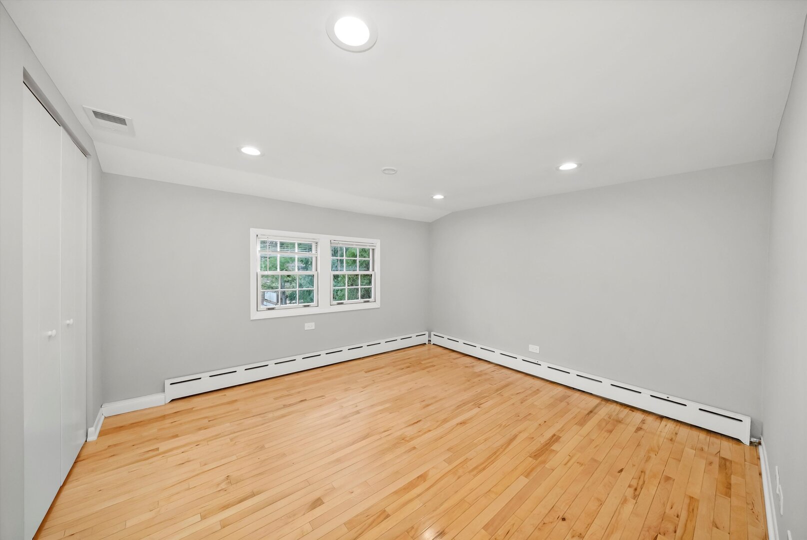452 Deerpath Road Wood Dale, IL 60191 - Photo 20 of 50 an empty room with wooden floor and windows