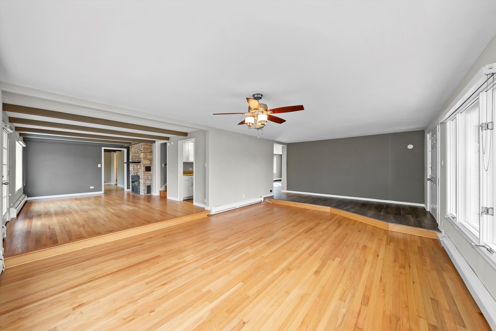 452 Deerpath Road Wood Dale, IL 60191 - Photo 7 of 50 a view of a livingroom with wooden floor and ceiling fan