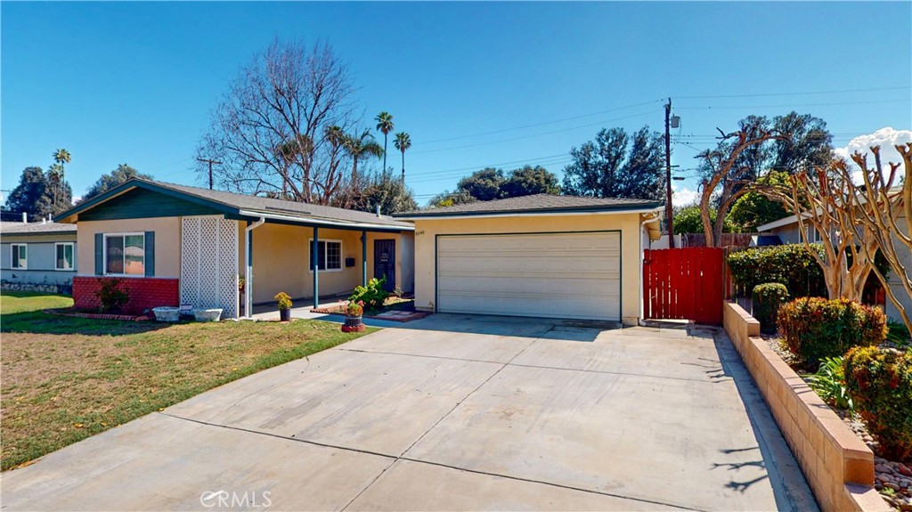 8240 Garfield Street Riverside, CA 92504 - Photo 1 of 1 a view of a house with a yard and potted plants