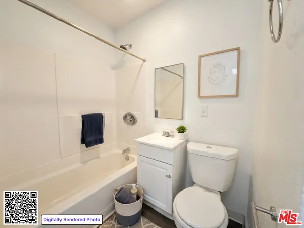 a white toilet sitting next to a bathroom sink and tub