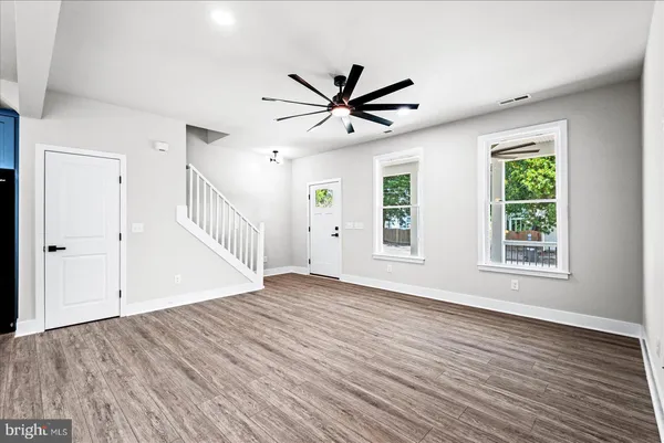 a large kitchen with stainless steel appliances and wooden cabinets