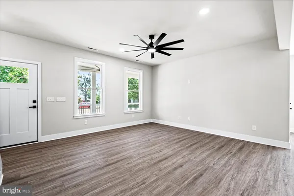 a kitchen with a sink a center island wooden floor and a window