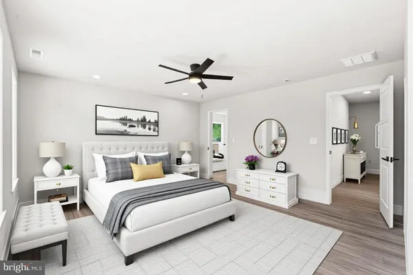 a view of room with wooden floor and ceiling fan