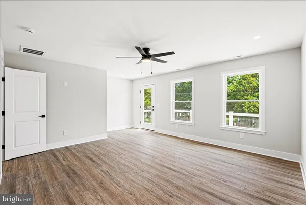 a bathroom with a toilet a double vanity sink and a mirror