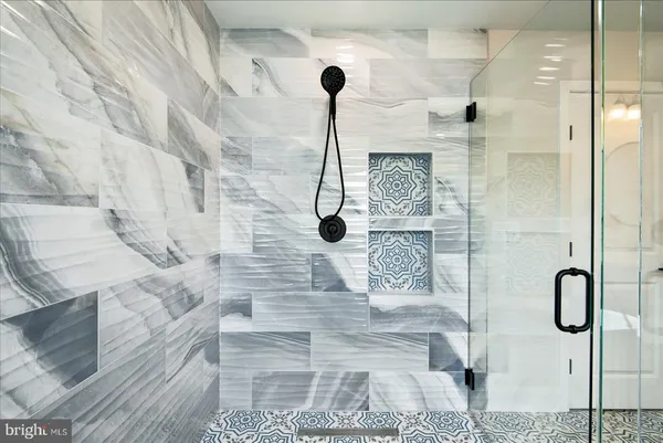 a view of a livingroom with wooden floor and a ceiling fan