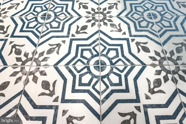 an empty room with wooden floor ceiling fan and windows