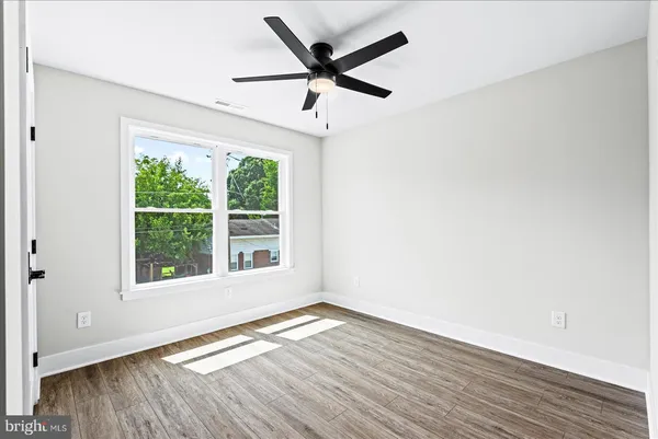 a view of a porch with a floor to ceiling window and wooden floor