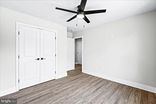 a front view of a house with a tree