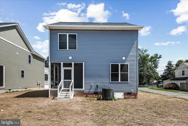 an aerial view of residential houses with outdoor space and street view