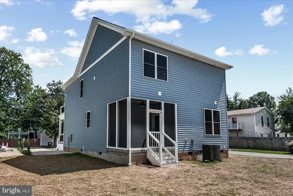 an aerial view of residential houses with outdoor space and trees all around
