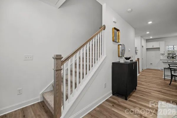 a view of entryway with wooden floor and stairs