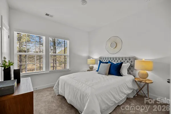 a bedroom with bed and window