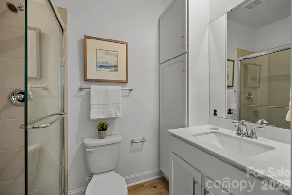 a bathroom with a sink toilet and shower