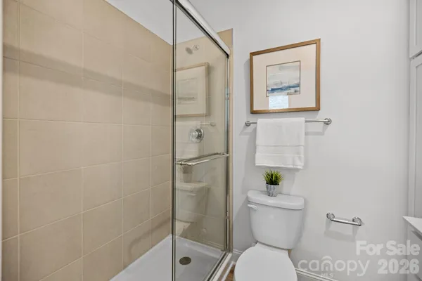 a bathroom with a toilet and a shower