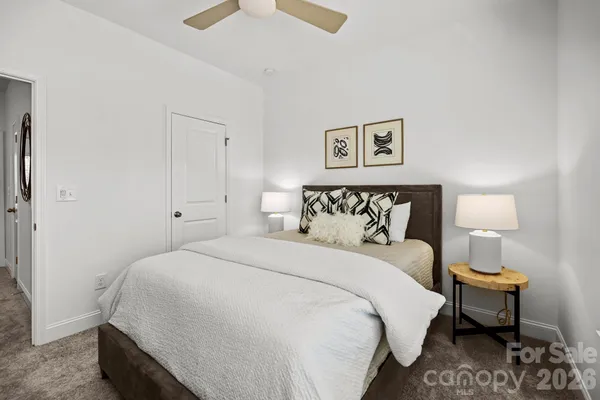 a bedroom with bed and a night stand