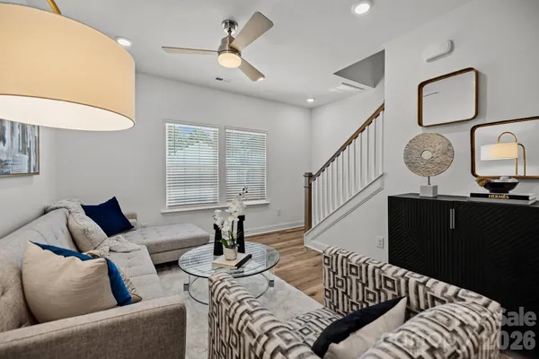 a living room with furniture and wooden floor