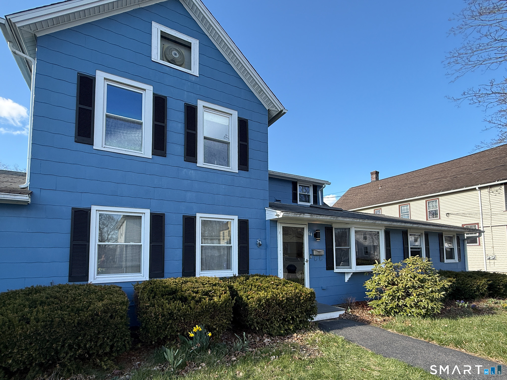 a view of a brick house with many windows and yard