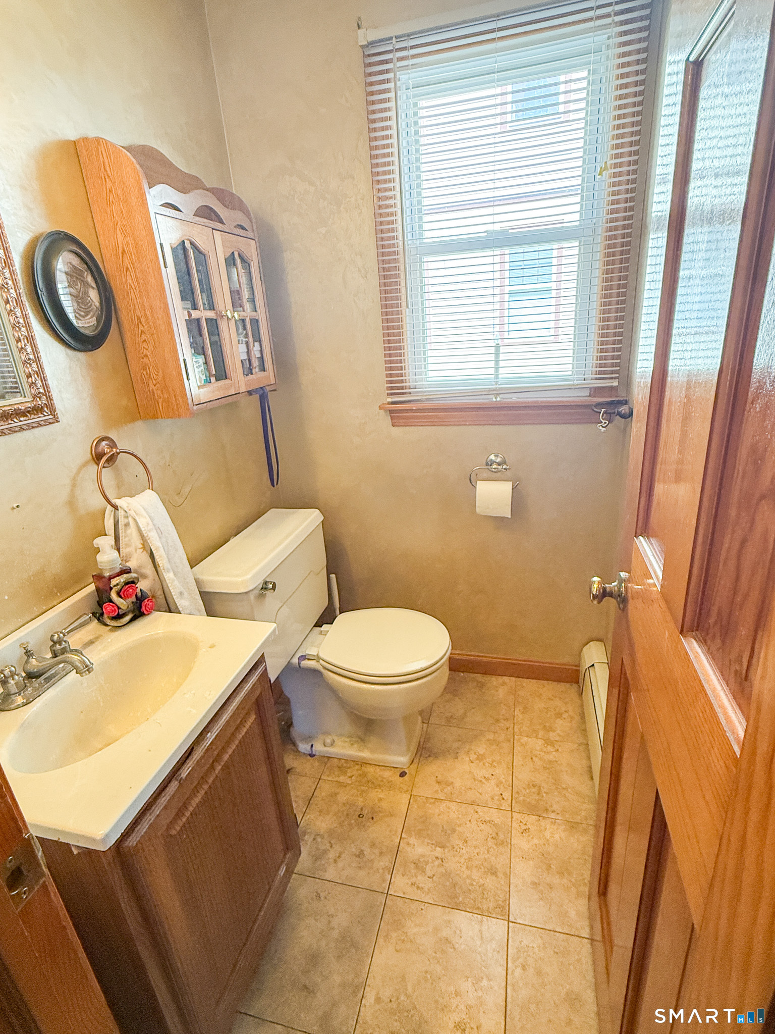 64 Hoffman Street Torrington, CT 06790 - Photo 12 of 27 a bathroom with a toilet a sink and a mirror