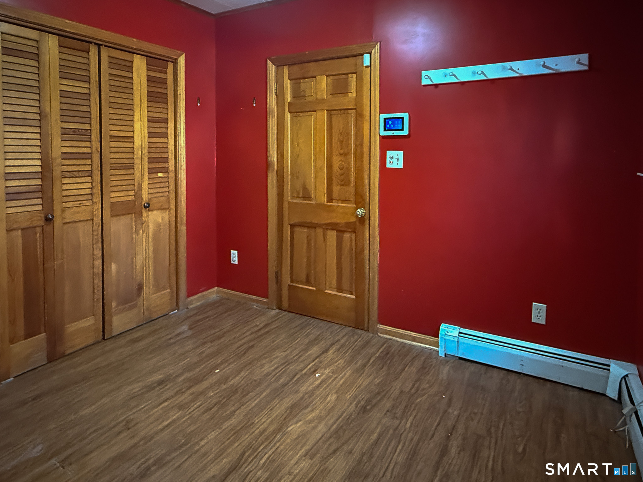 64 Hoffman Street Torrington, CT 06790 - Photo 19 of 27 a view of an empty room with wooden floor and windows