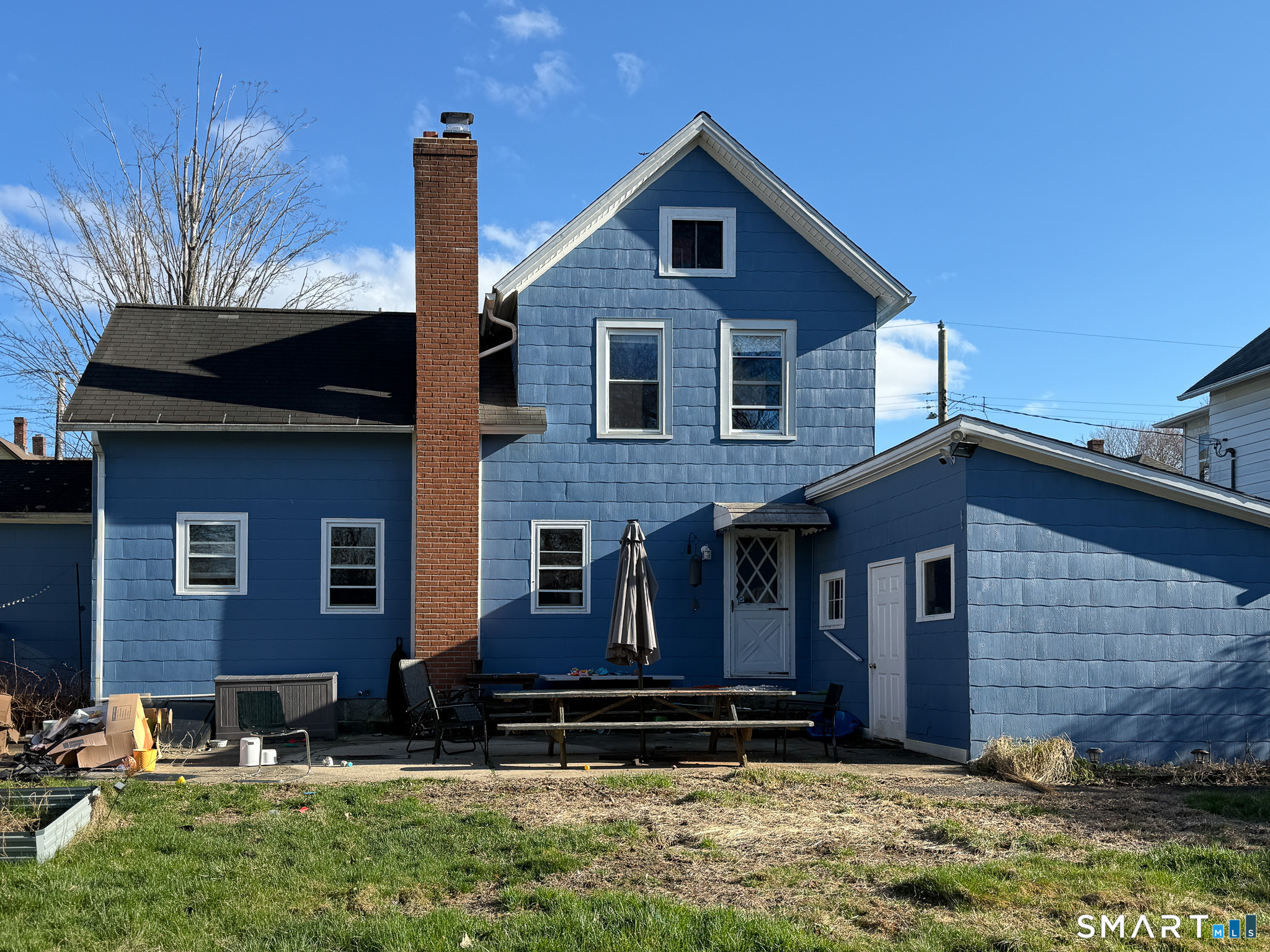 64 Hoffman Street Torrington, CT 06790 - Photo 24 of 27 a view of a brick house with a yard and large trees
