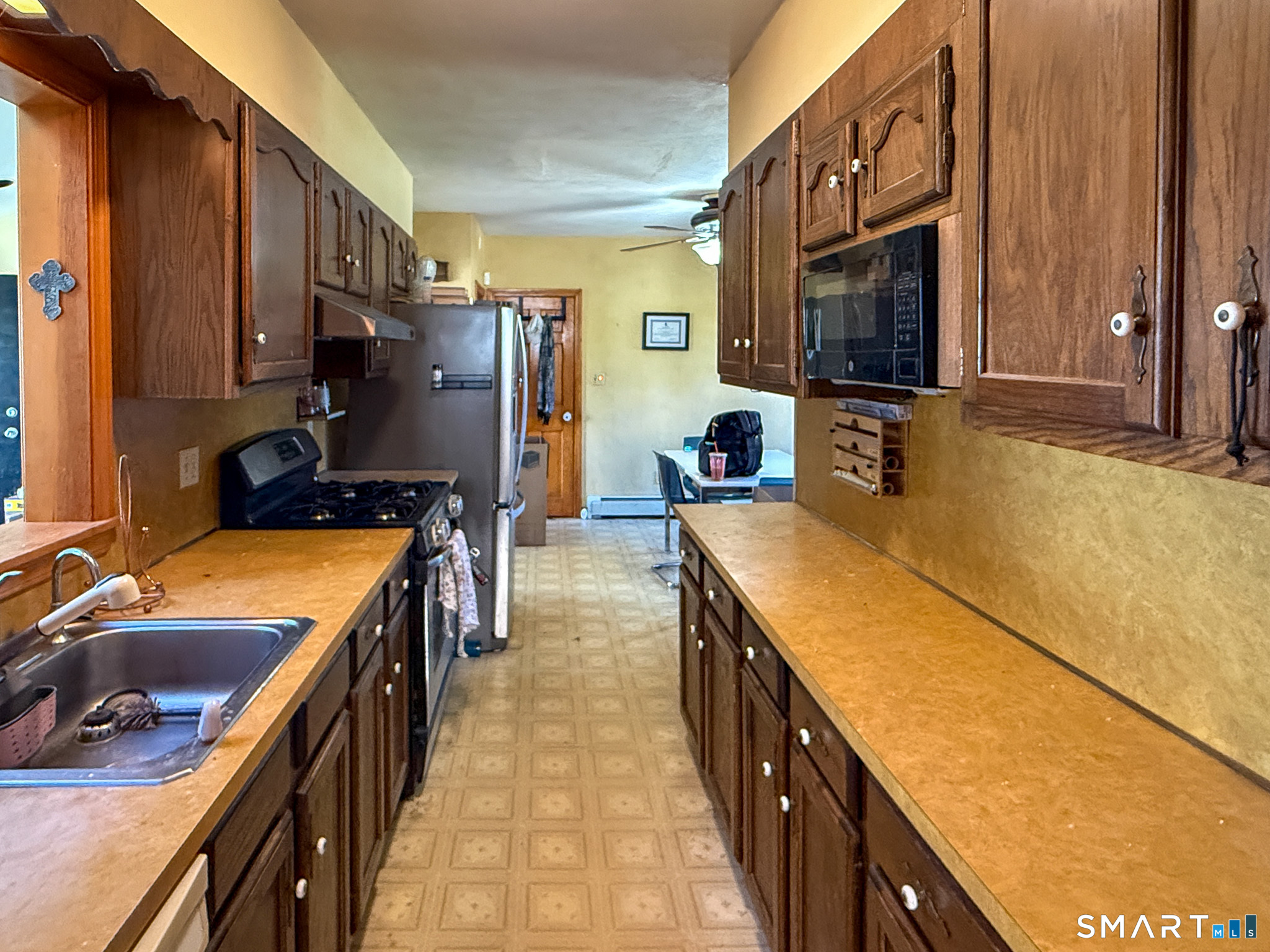 64 Hoffman Street Torrington, CT 06790 - Photo 9 of 27 a kitchen with a stove a sink and a refrigerator