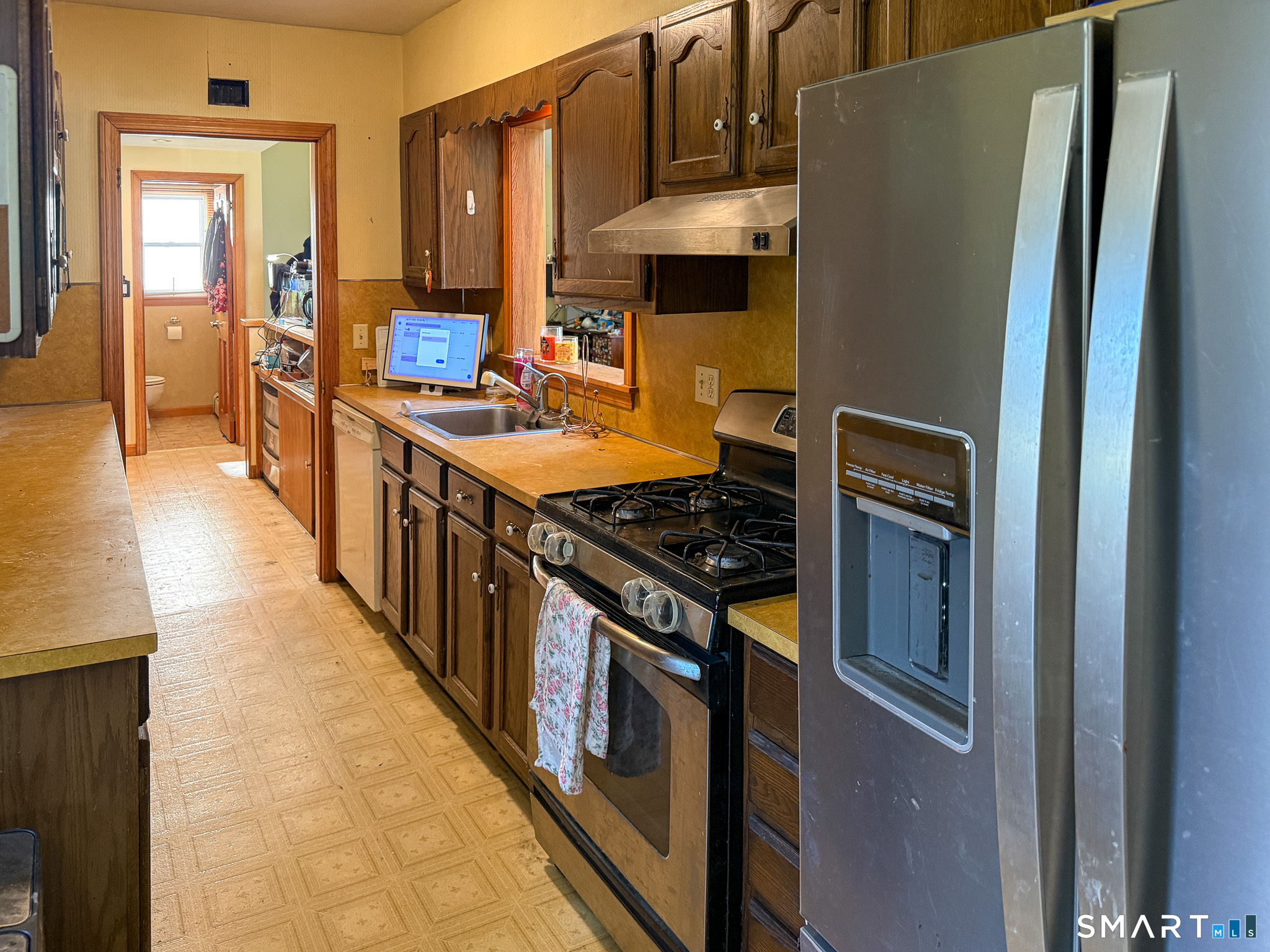 64 Hoffman Street Torrington, CT 06790 - Photo 10 of 27 a kitchen with stainless steel appliances granite countertop a stove a refrigerator and a stove