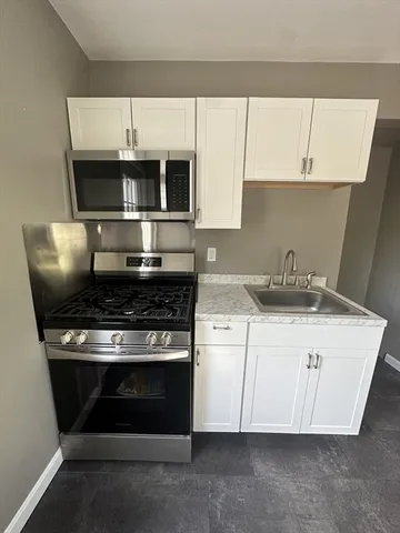 a kitchen with a stove and a microwave
