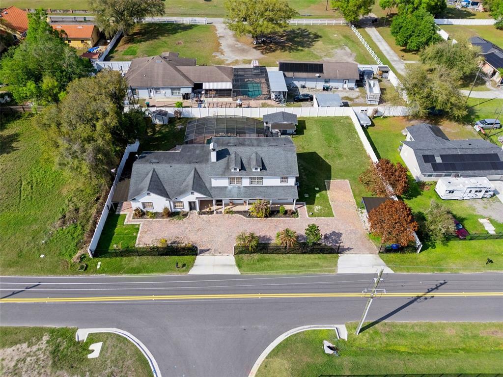 an aerial view of a house with garden space and street view