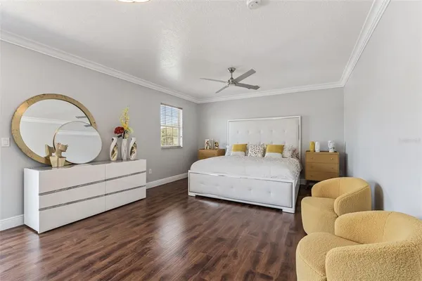 a bedroom with furniture and a mirror