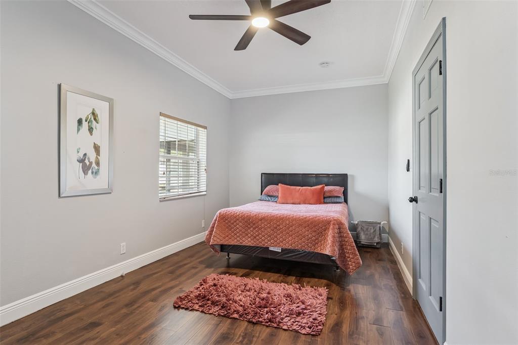 6053 New Hope Road Orlando, FL 32824 - Photo 16 of 40 a bedroom with a bed and wooden floor