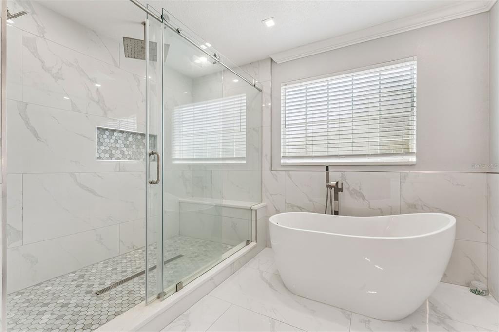 6053 New Hope Road Orlando, FL 32824 - Photo 21 of 40 a white bath tub sitting next to a shower