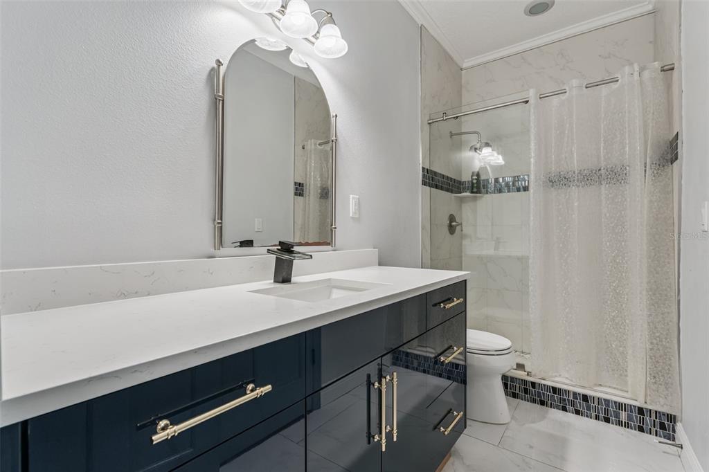 6053 New Hope Road Orlando, FL 32824 - Photo 22 of 40 a bathroom with a sink a vanity and a mirror